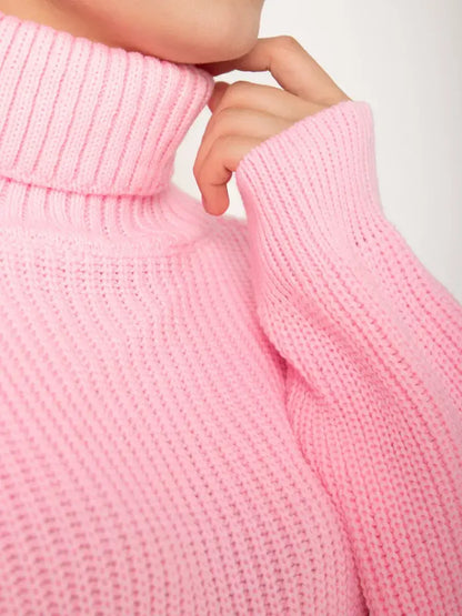 Close-up of the high neck of the Blossom Pullover by Lauven, showcasing its soft light pink chunky knit texture.