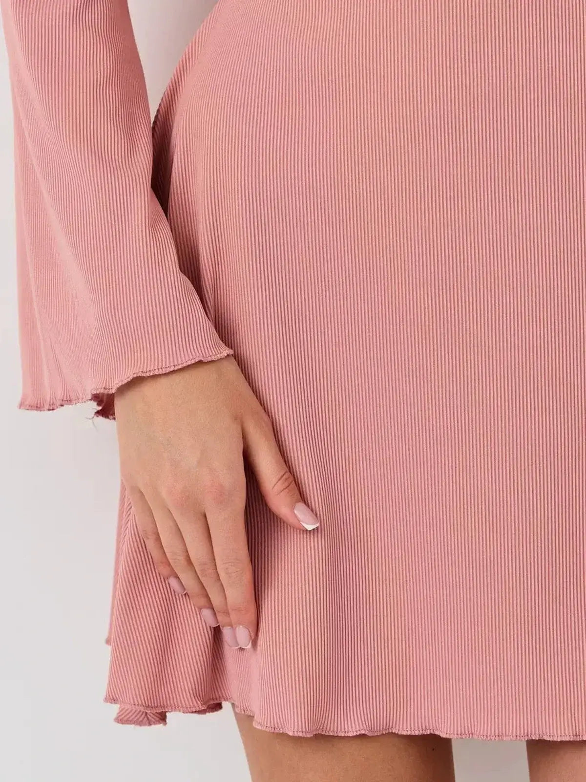 Close-up of the Blush Aura mini dress by Lauven, showcasing the soft fabric and flared hemline for summer elegance.