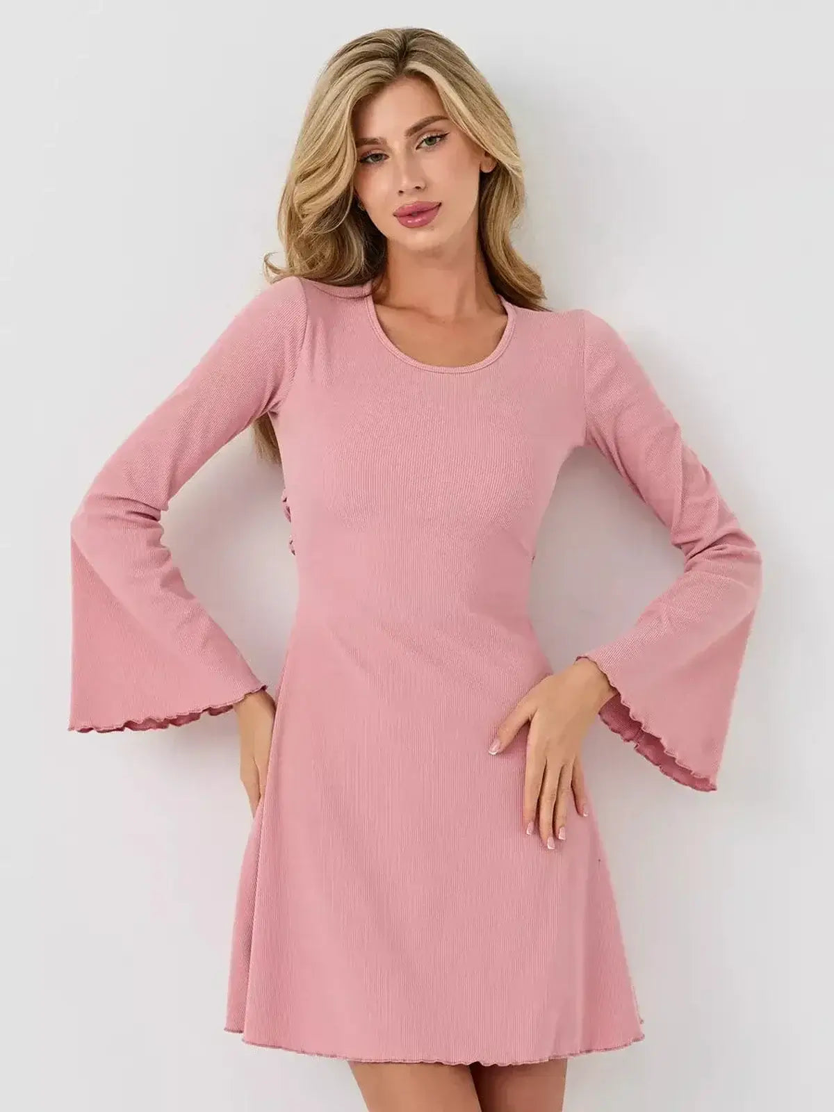 Blush Flare dress by Lauven featuring a flirty A-line silhouette and bell sleeves in soft pink.