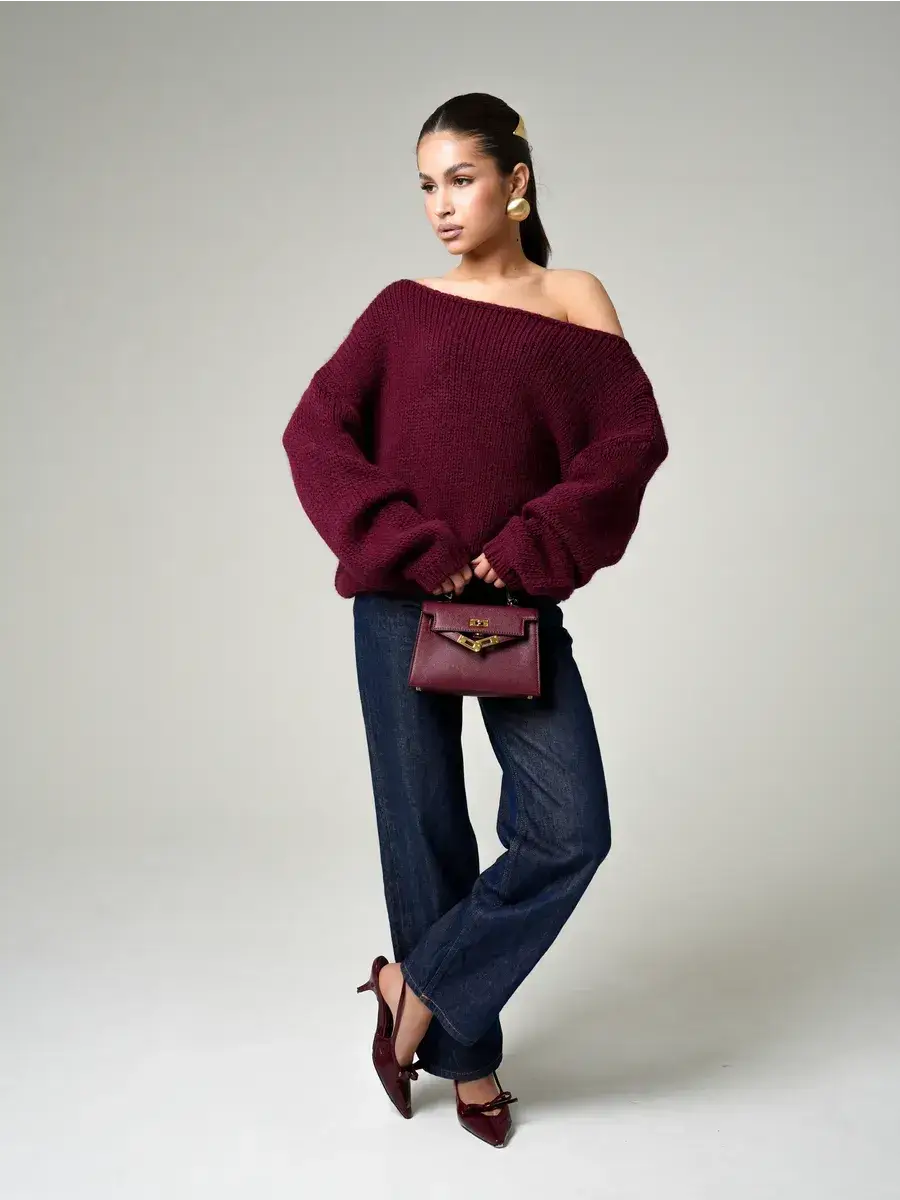 Bordeaux Sweater by Lauven, oversized off-shoulder knit in deep wine, styled with denim and chic accessories.
