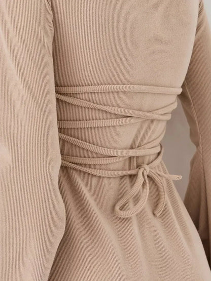 Close-up of the back detail of the Café Ribbon mini dress by Lauven, showcasing its ribbed texture and tie design.