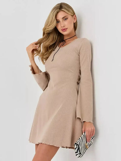 Effortlessly stylish woman in Café Ribbon dress by Lauven, showcasing a ribbed design and bell sleeves in warm beige.