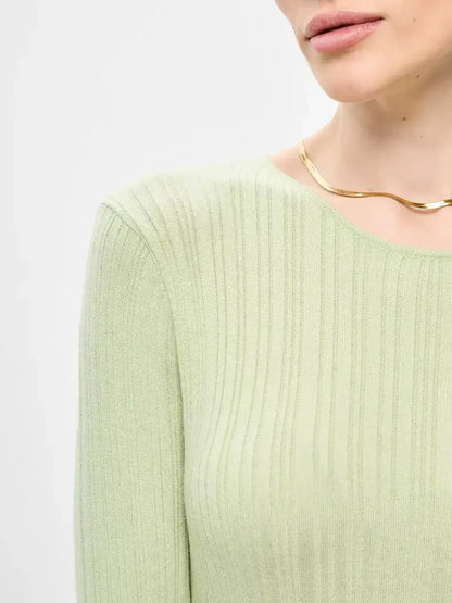 Close-up of the Celery Luxe Maxi Dress by Lauven, showcasing the light green ribbed-knit texture and elegant neckline.