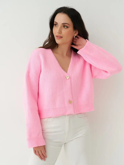 Celeste Cardigan from Lauven, a cropped pink knit cardigan with heart buttons, perfect for elegant and casual looks.