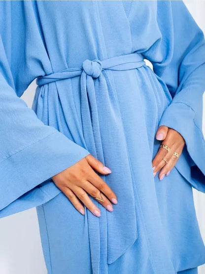 Celeste Suit Set by Lauven featuring an elegant soft blue oversized kimono robe with tied belt.