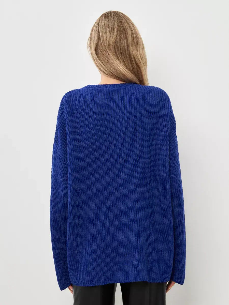 Back view of a woman wearing the oversized electric blue knit Celeste Sweater by Lauven.