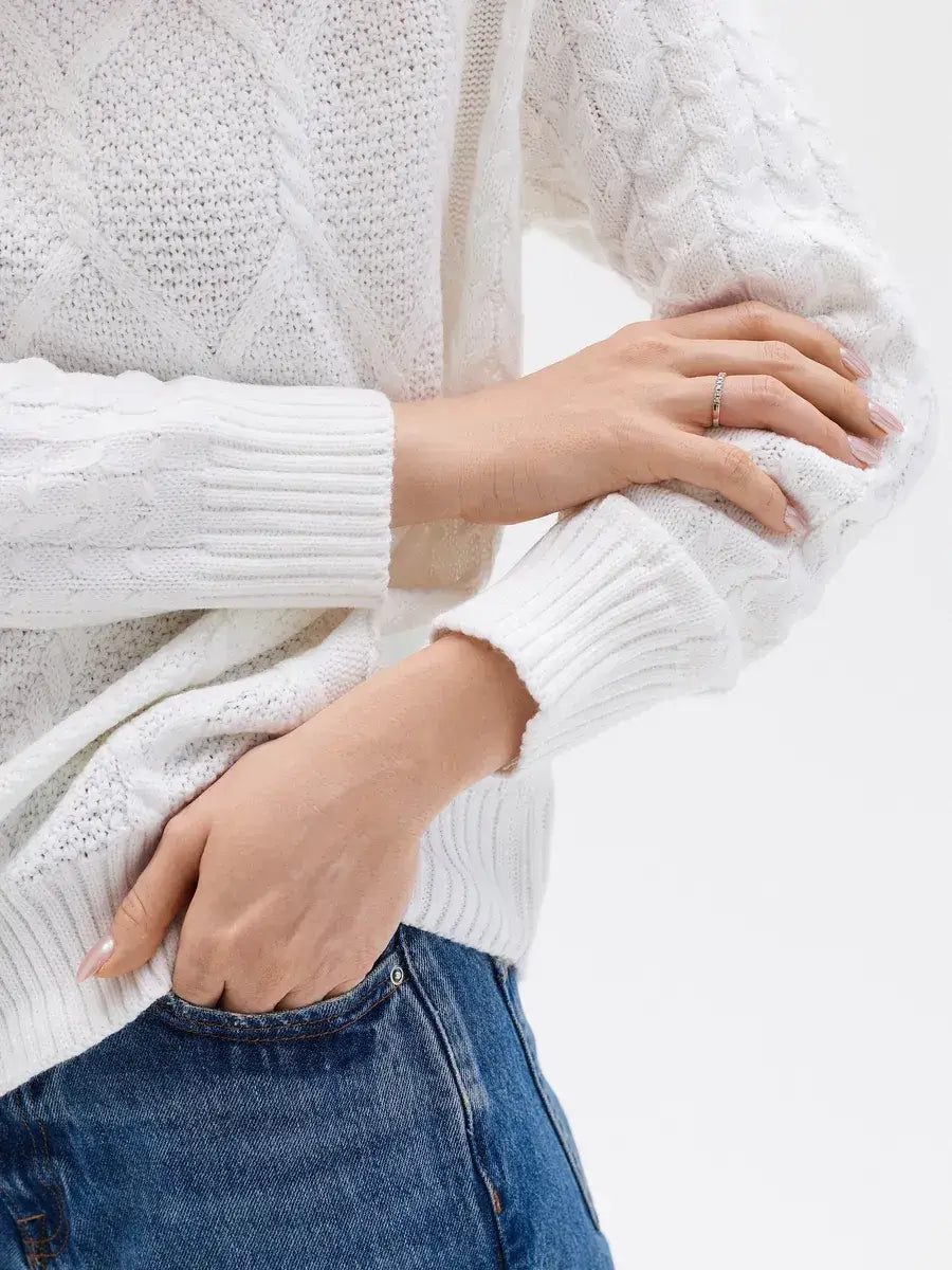 Celeste Sweater by Lauven featuring elegant white knitwear with patterned sleeves and a stylish cable knit design.