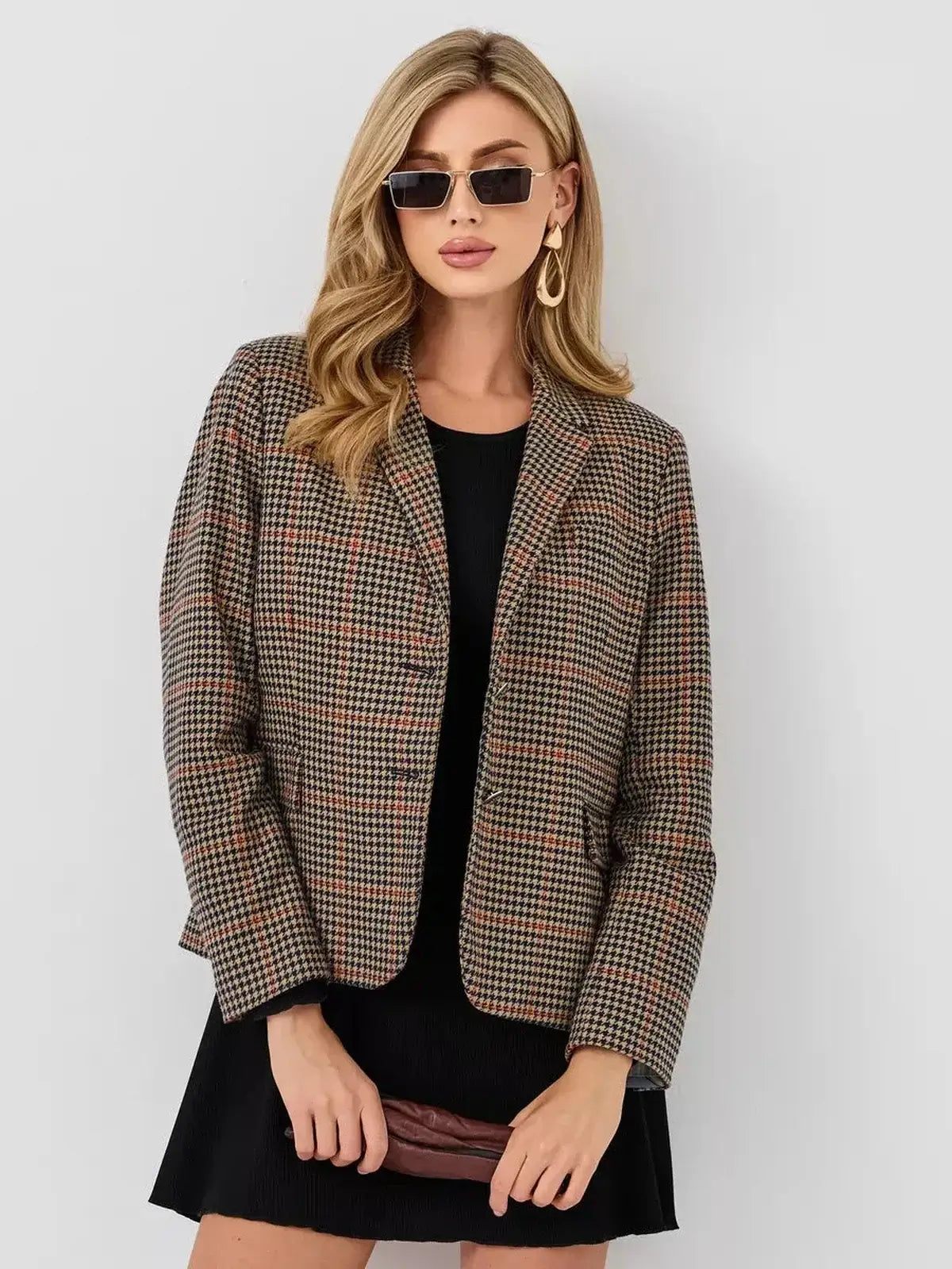Model showcasing Lauven's stylish plaid blazer paired with a mini dress, exuding modern elegance and sophistication.