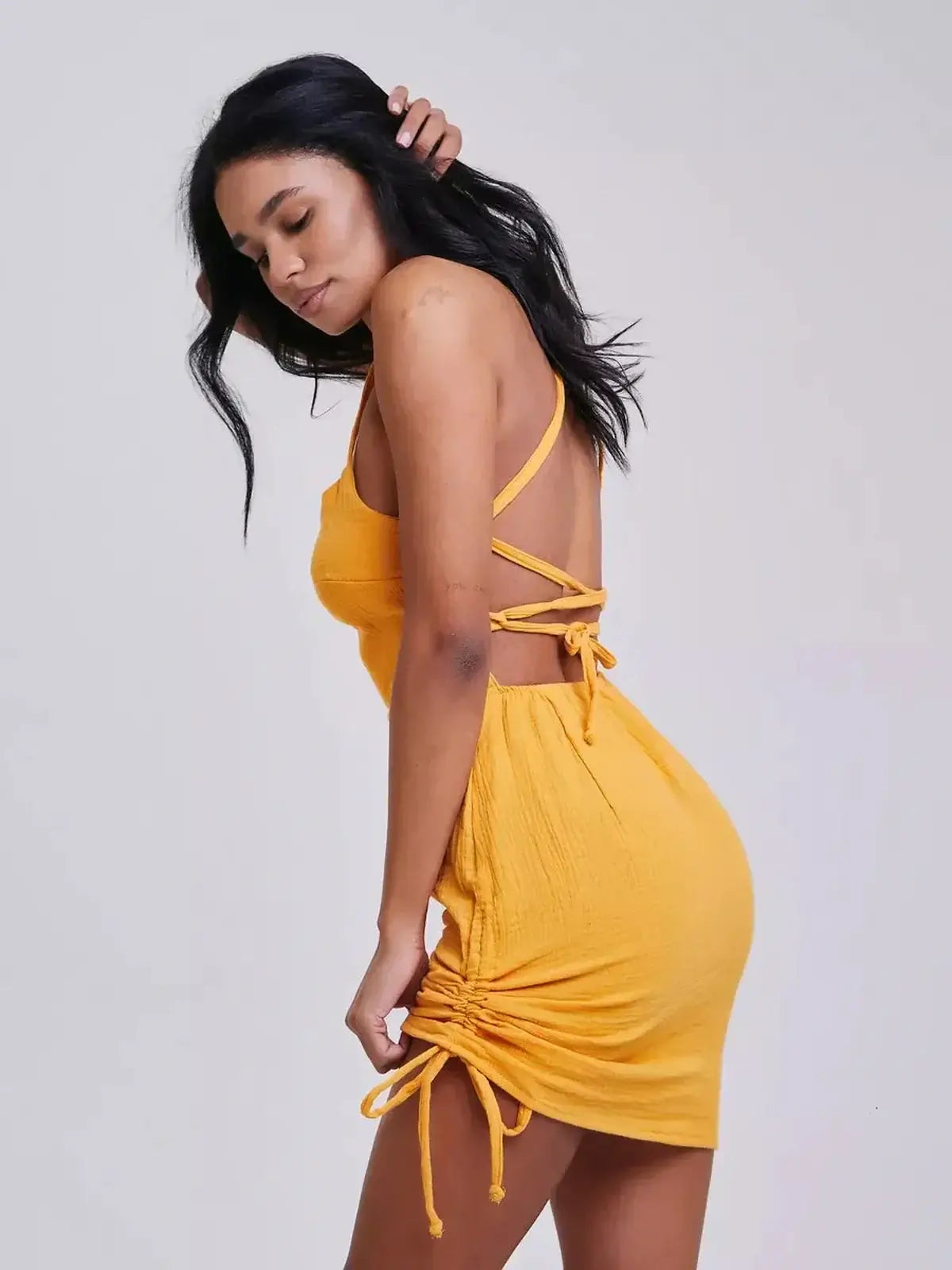 Citrus Rush by Lauven, featuring bold yellow color, crisscross straps, and flattering bodycon silhouette.