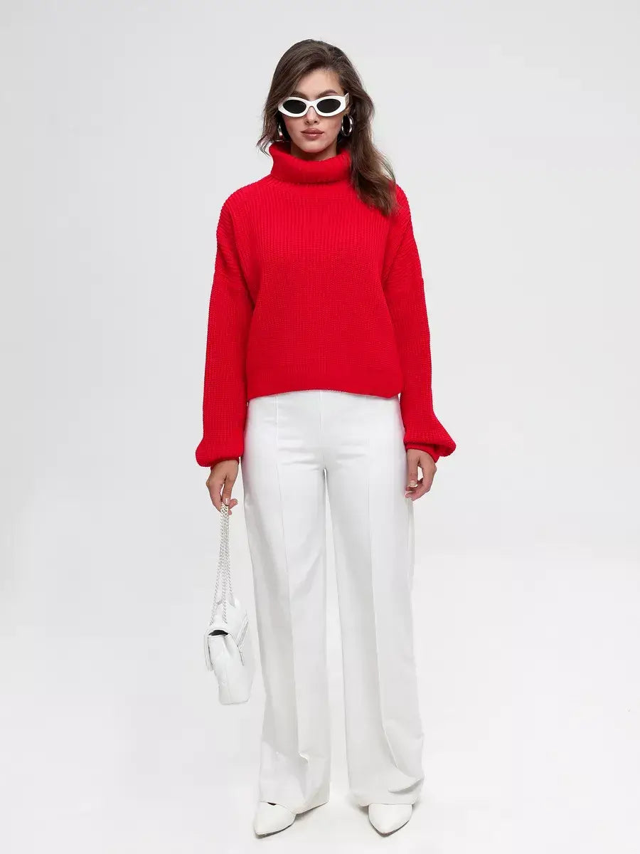 Ember Pullover - Oversized Knit Sweater by Lauven in red, paired with white wide-leg trousers and stylish sunglasses.