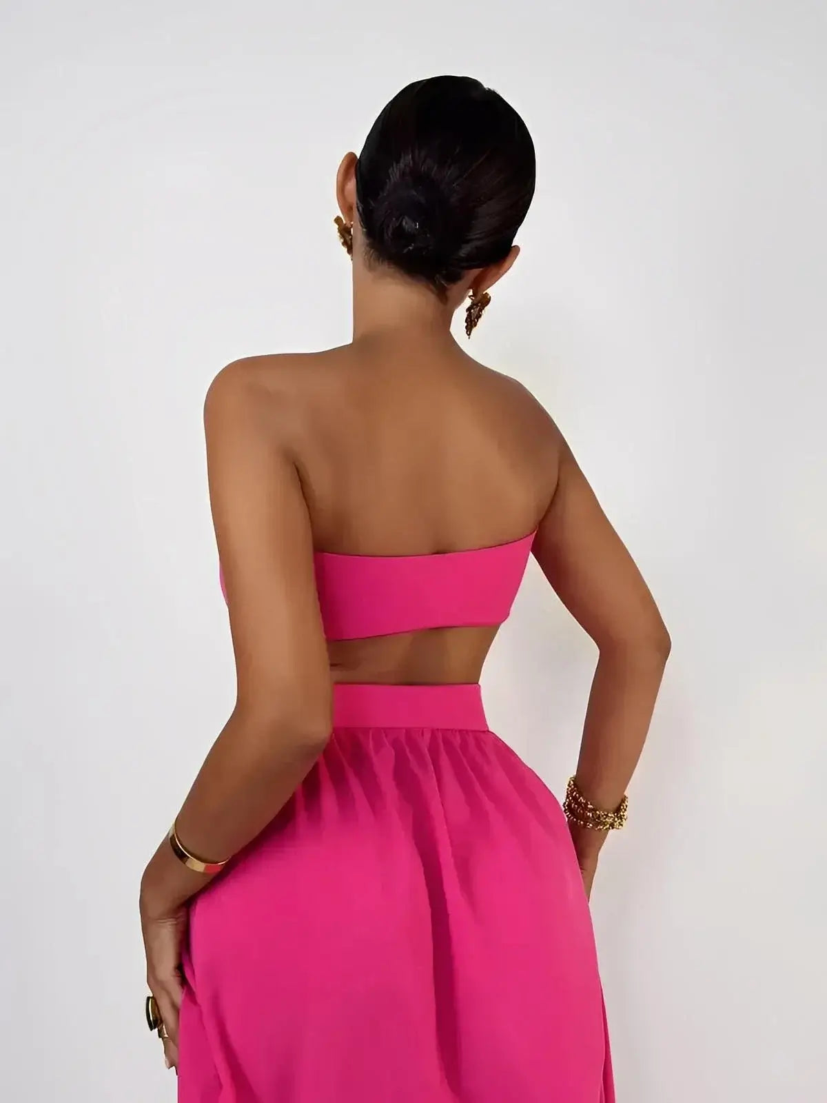 Model wearing the Fuchsia Breeze Set, showcasing a criss-cross top and flowing skirt in vibrant fuchsia.