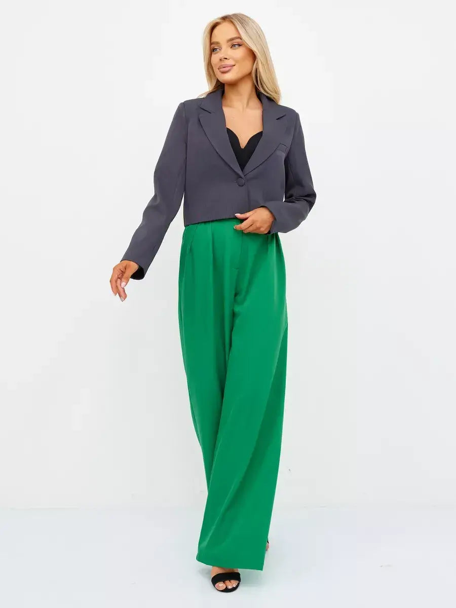 Graphite Blazer by Lauven, a cropped tailored classic in dark gray, styled with green wide-leg pants.