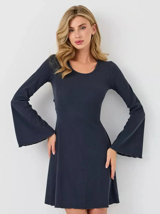 Model wearing the Graphite Grace mini dress by Lauven, showcasing a flattering fit and bell sleeves.