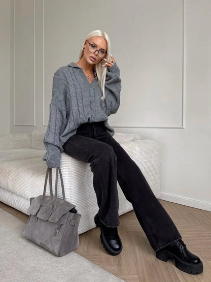 Model wearing a Graphite Sweater by Lauven, showcasing oversized cable knit design and V-neckline.