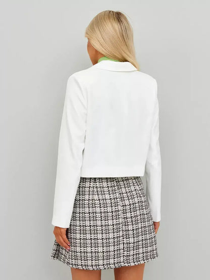 Back view of a model wearing a Lauven Ivory Blazer paired with a patterned skirt, showcasing classic cropped elegance.