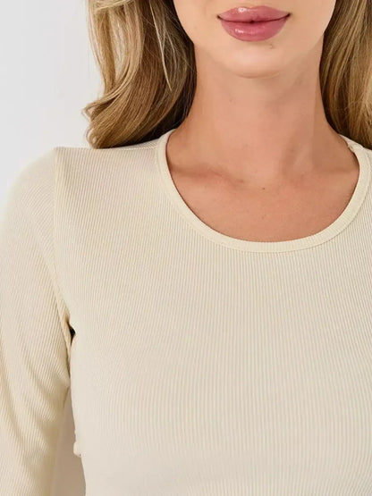 Close-up of the ribbed texture of the Ivory Flare dress by Lauven, showcasing its elegant neckline and soft fabric.