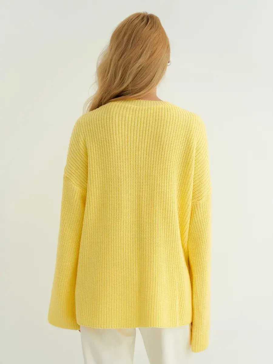 Back view of the Lemonade Sweater by Lauven, showcasing its oversized fit and soft lemon yellow knit.