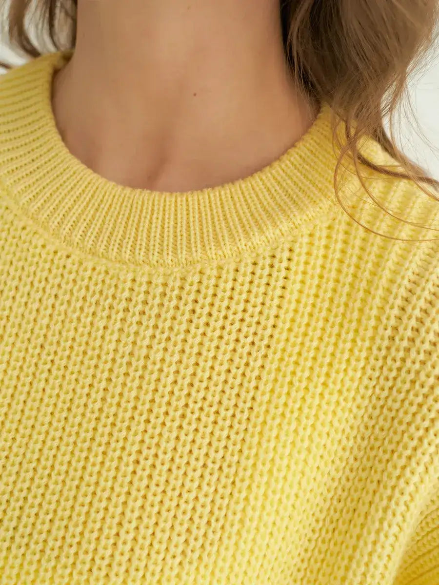 Close-up of the Lemonade Sweater by Lauven, showcasing its bright yellow knit texture and oversized fit.