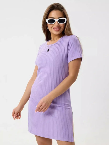 Model wearing Lilac Ripple mini dress by Lauven in light violet with sunglasses, showcasing ribbed knit texture.