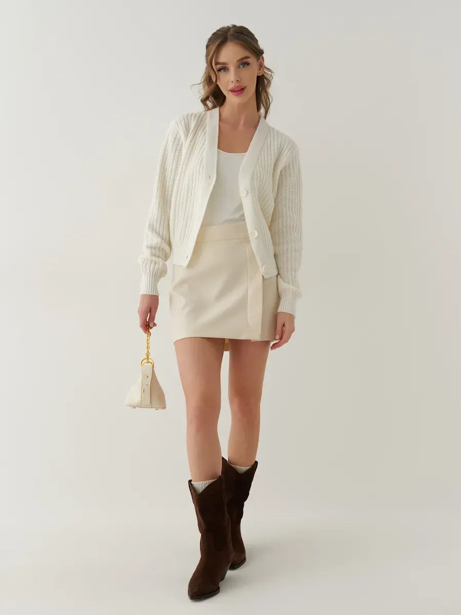 Luna Cardigan by Lauven, oversized cropped knitwear in cream, styled chicly with a skirt and knee-high boots.
