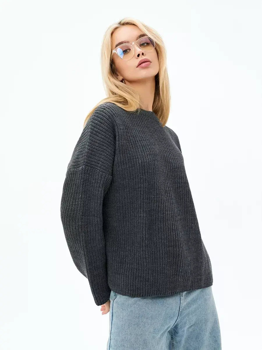 Model wearing the Luna Sweater by Lauven, an oversized knit in charcoal gray for a chic and relaxed look.