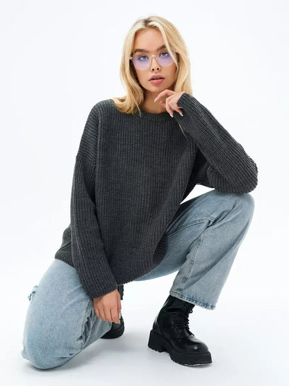 Luna Sweater by Lauven, oversized knit in charcoal gray worn with jeans and fashionable boots.