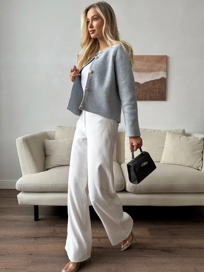 Marin Cardigan by Lauven - Elegant light gray cropped knitwear styled with white pants and a chic handbag.