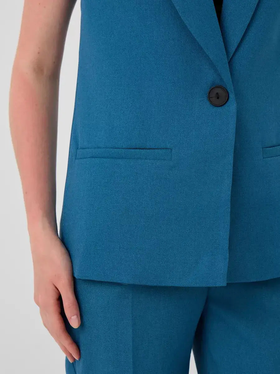 Marine Suit Set by Lauven – Close-up of sleeveless teal vest showcasing tailored design.