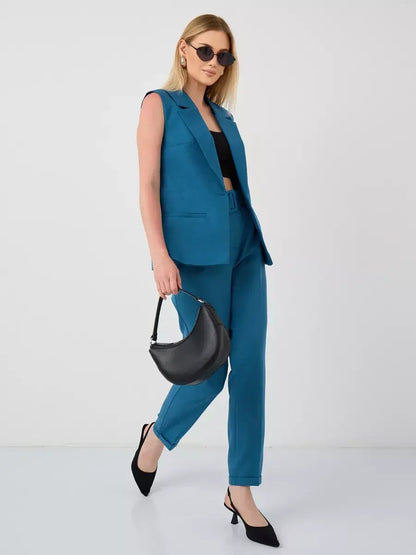 Stylish woman wearing Lauven Marine Suit Set with sleeveless teal vest and high-waist pants.