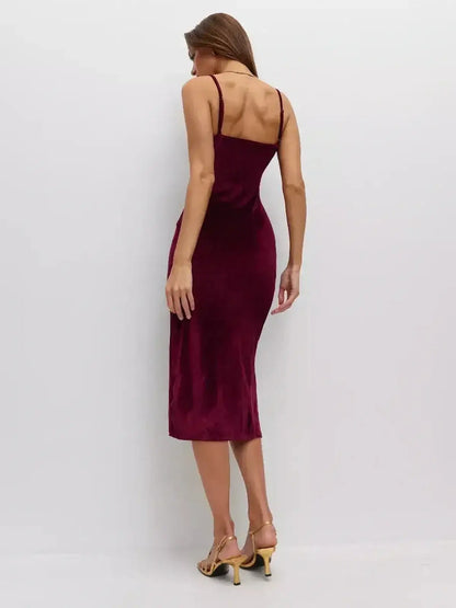 Back view of a woman in a Midi Dress Velvet Crush by Lauven, showcasing the luxurious velvet texture and form-fitting design.