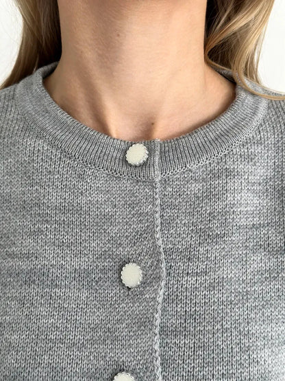 Mist Cardigan by Lauven, featuring a cozy gray knit texture and stylish button details, perfect for layering.