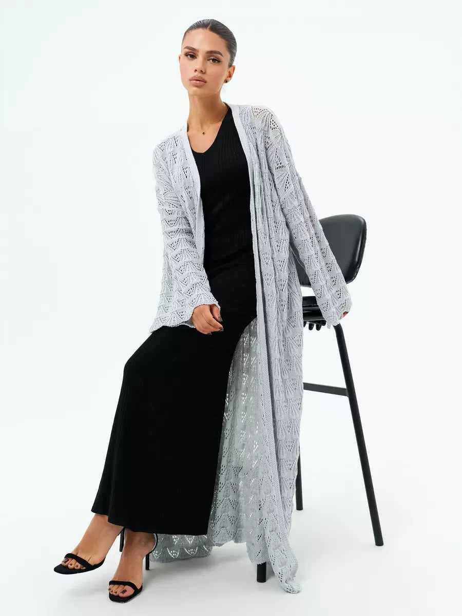 Mist Cardigan by Lauven featuring a lightweight openwork design in light gray, styled with a black dress.