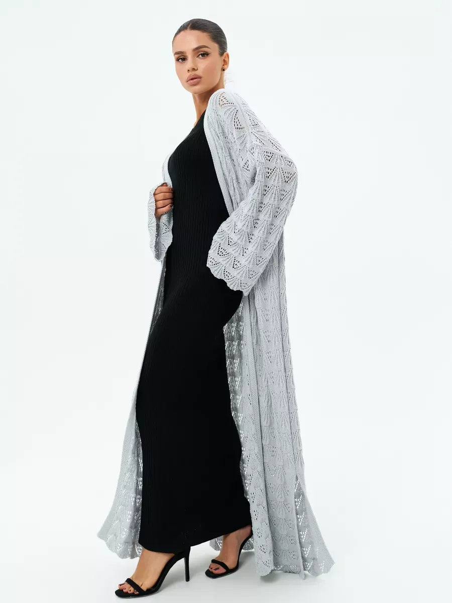 Mist Cardigan by Lauven, lightweight openwork summer cardigan in soft light gray worn over a black dress.