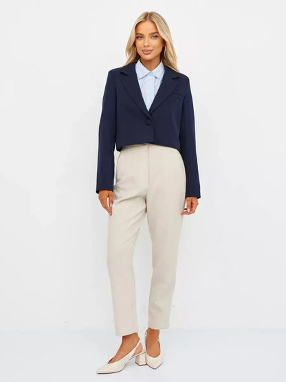 Navy Blazer by Lauven worn with beige trousers for a chic, cropped tailored look.