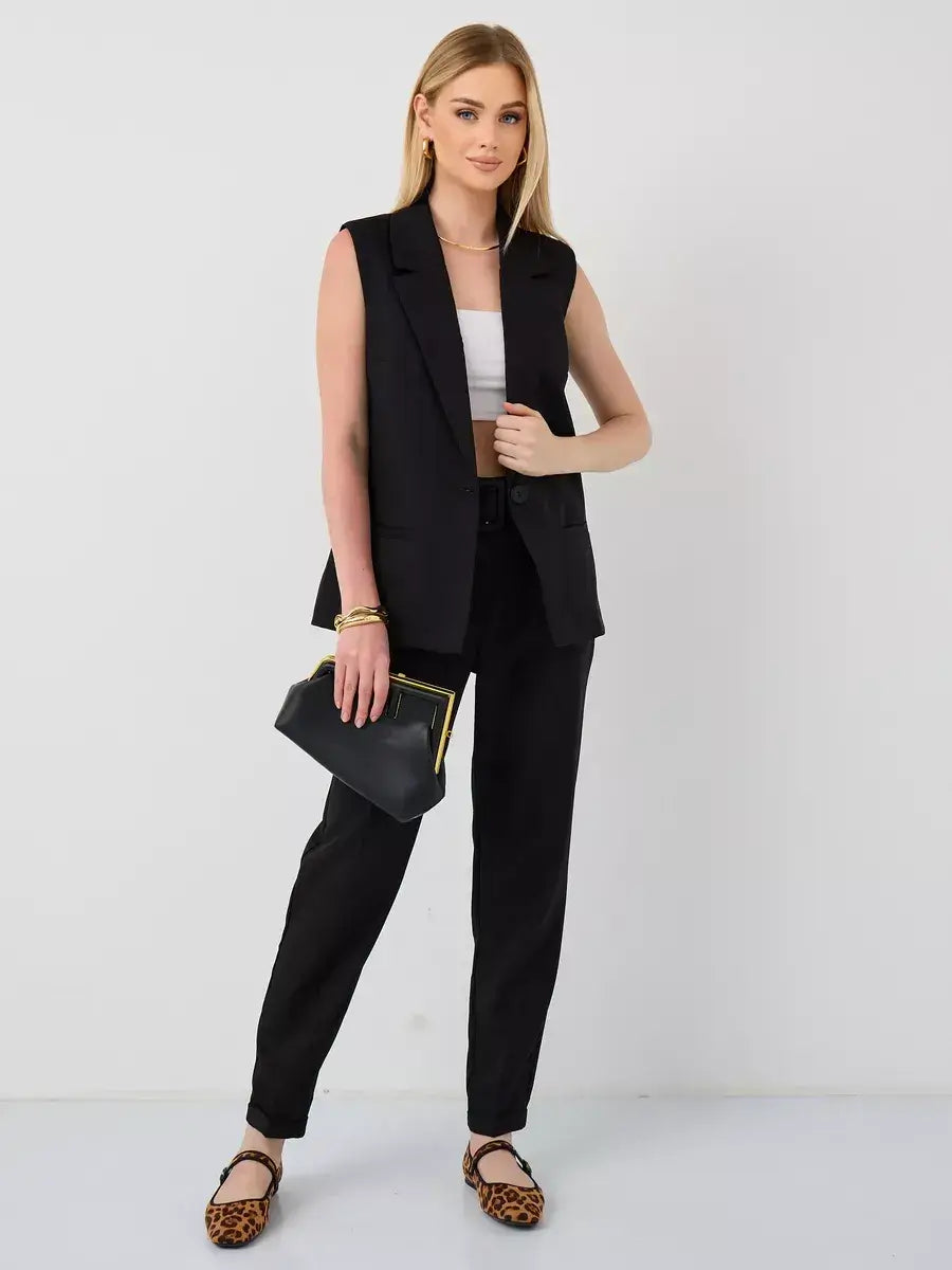 Model showcasing Noir Suit Set by Lauven, featuring a sleeveless black vest and high-waist trousers.