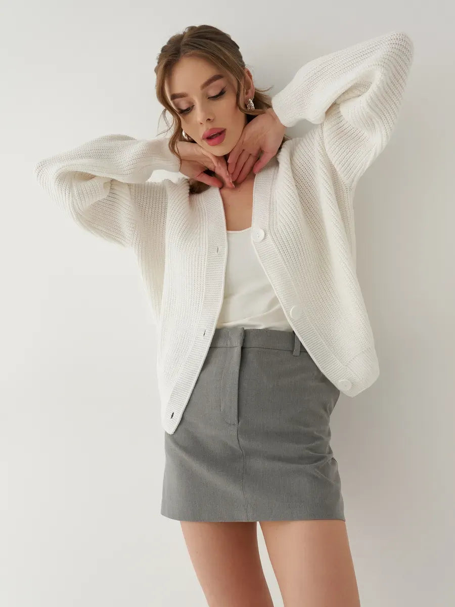 Chic Pearl Cardigan by Lauven, oversized knitwear in white, featuring a button-front design, styled with a skirt.