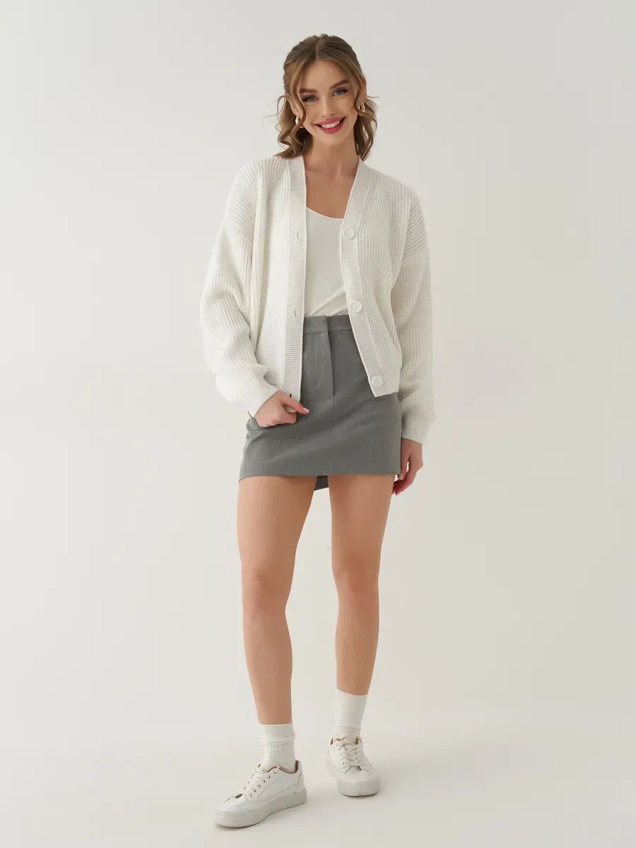 Pearl Cardigan by Lauven styled with a white top and gray skirt, showcasing a chic oversized fit.