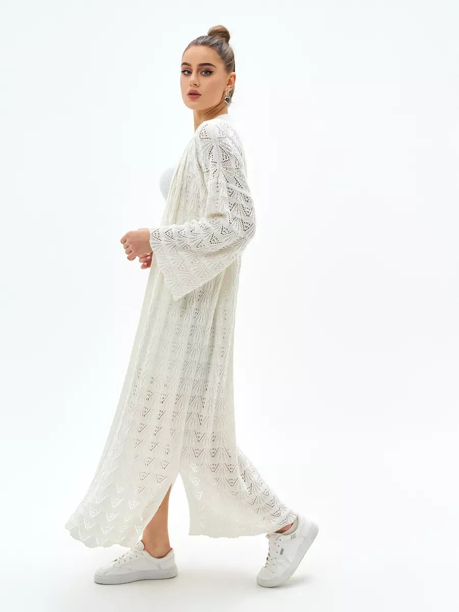 Stylish woman wearing a Pearl Cardigan by Lauven, showcasing the lightweight design and intricate lace pattern.