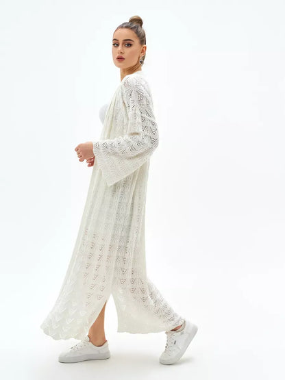 Stylish woman wearing a Pearl Cardigan by Lauven, showcasing the lightweight design and intricate lace pattern.