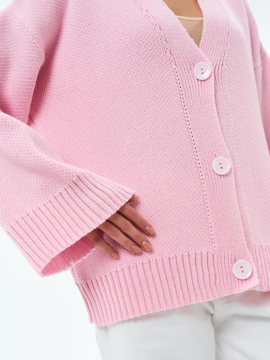 Soft pastel pink Petal Cardigan by Lauven, featuring oversized knitwear and button closure for comfort and style.