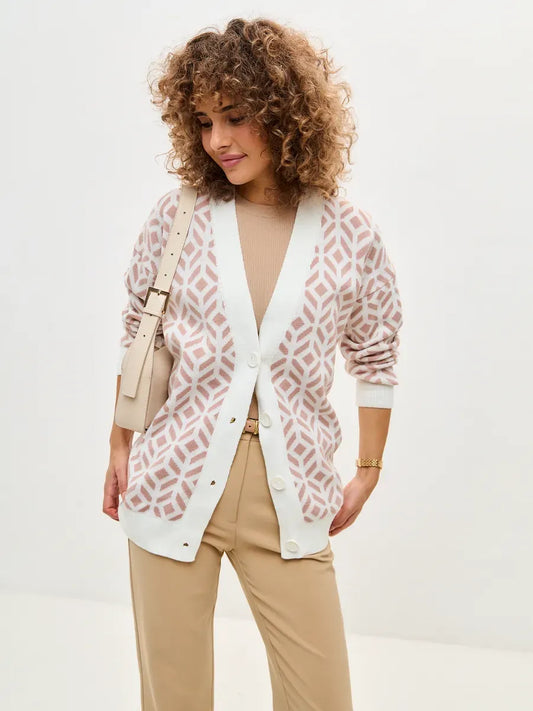 Model wearing a Powder Cardigan in milk and powder pink, showcasing its soft acrylic knit design from Lauven.