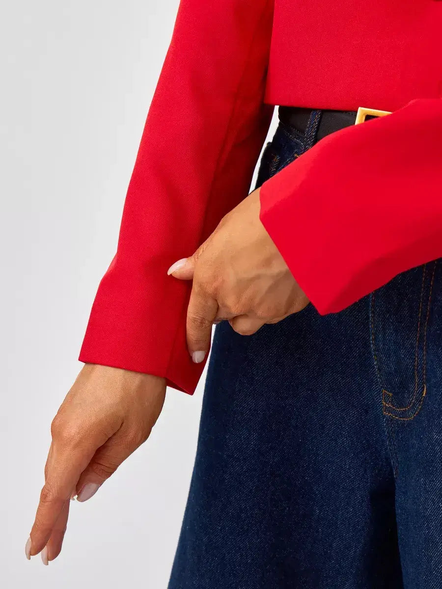 Close-up of the Ruby Blazer by Lauven, showcasing the vibrant red cropped sleeve and tailored fit.