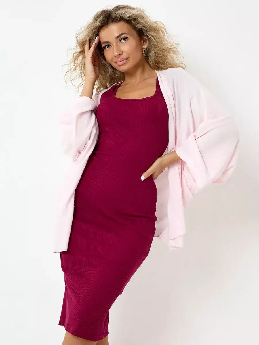 Model wearing a Ruby Midi Dress in wine color, styled with a pink cardigan for an elegant look by Lauven.