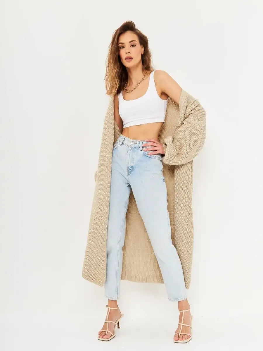 Model showcasing the Lauven Sable Cardigan, a long oversized knitwear coat styled with jeans and a crop top.