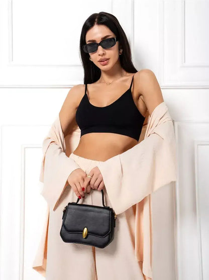 Sahara Suit Set by Lauven featuring a model in oversized beige two-piece with black top and stylish handbag.
