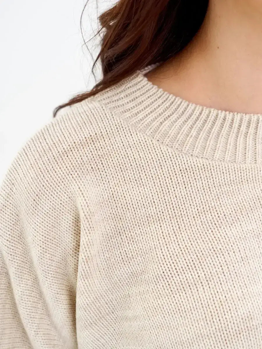 Cropped oversized knit Sand Sweater by Lauven in soft light beige color showcasing its breathable texture.