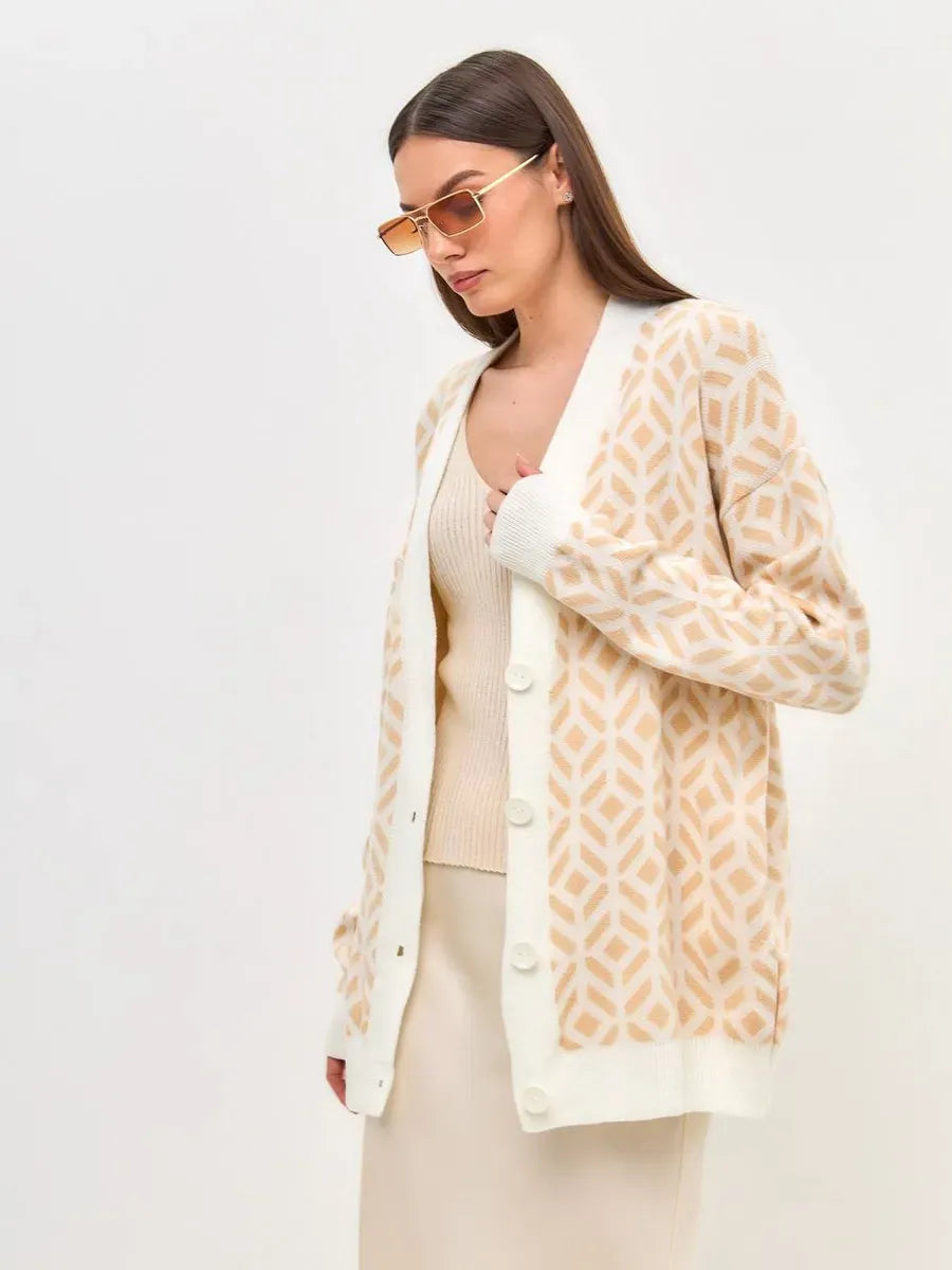 Sandy Cardigan by Lauven, a longline acrylic knitwear in soft beige featured on a model.