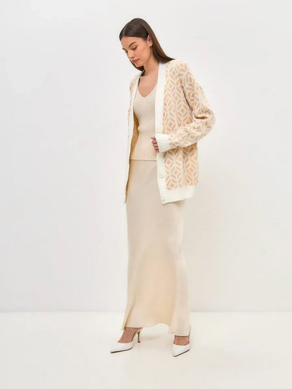 Sandy Cardigan by Lauven, model wearing lightweight longline knitwear in soft beige and sand tones.