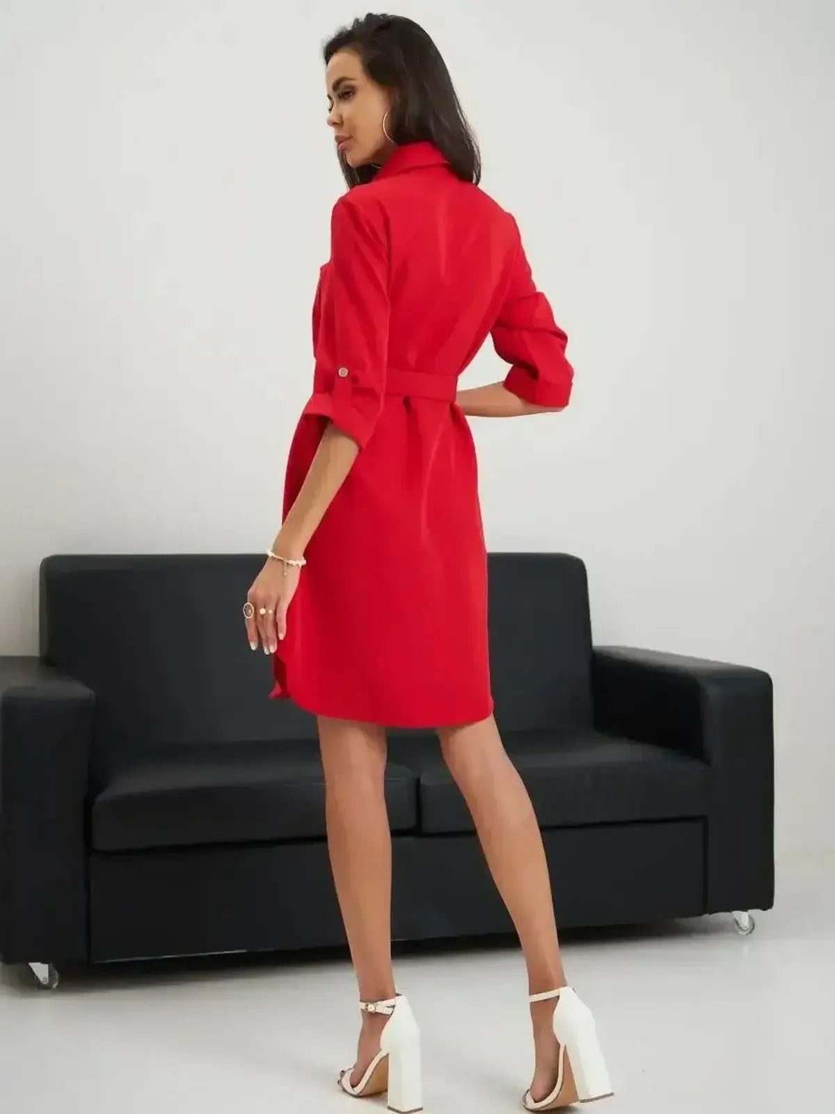 Model showcasing the back of the Scarlet Belted Mini dress by Lauven, featuring a vibrant red color and a tailored fit.
