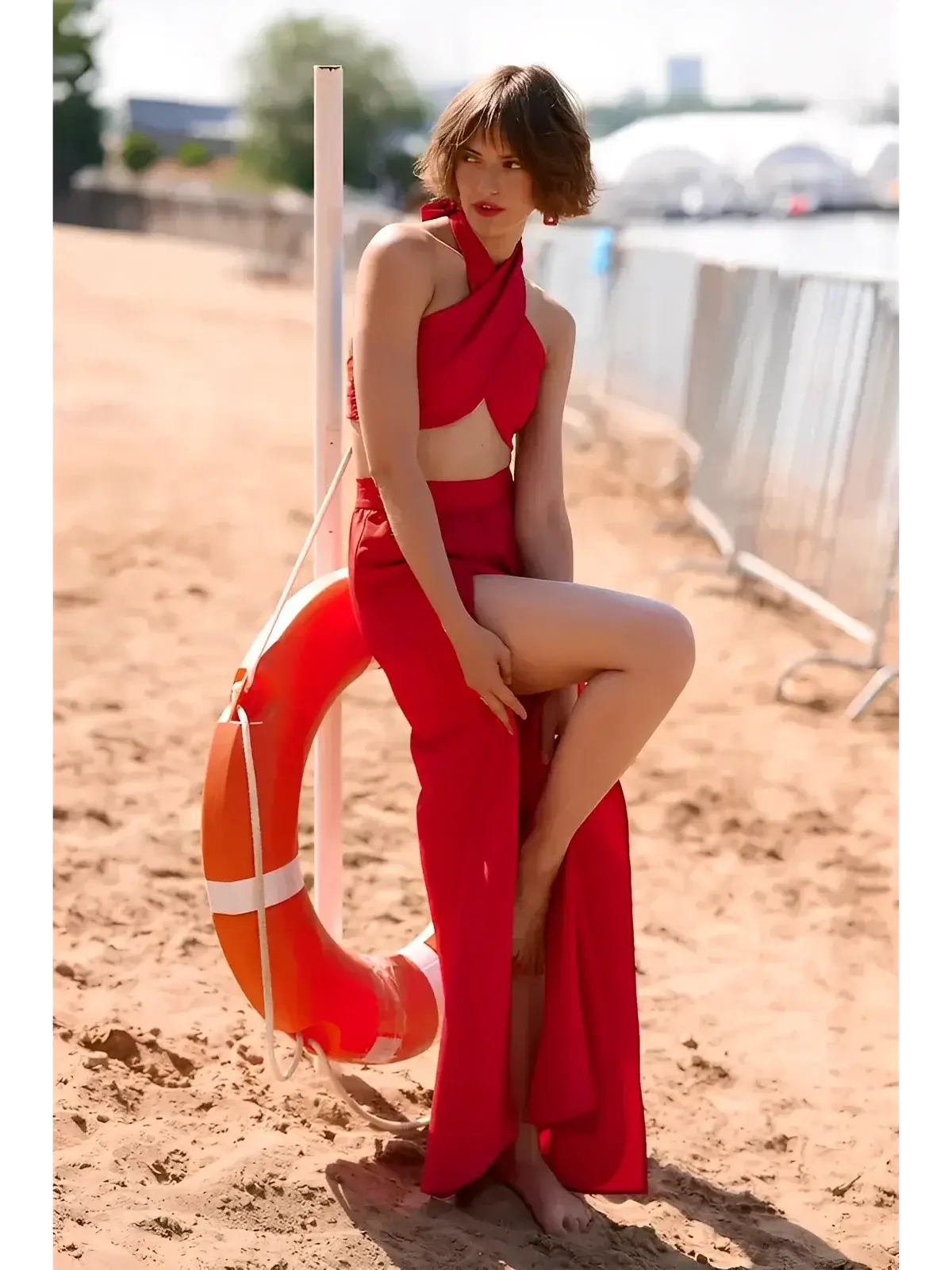 Model showcasing the Scarlet Mirage Set by Lauven, a stylish summer two-piece with draped top and high slit skirt.